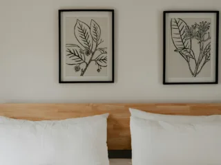 The framed prints give this bedroom a calm aesthetic.